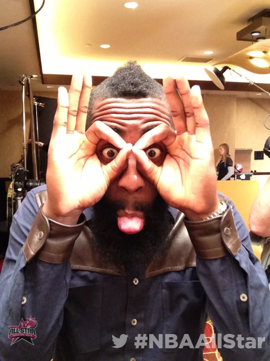Man playfully framing his eyes while posing with the Twitter Mirror at NBA All-Star Weekend.