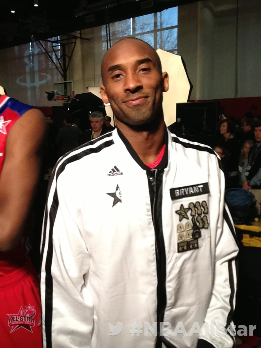 Man wearing a white jacket posing with the Twitter Mirror at NBA All-Star Weekend.