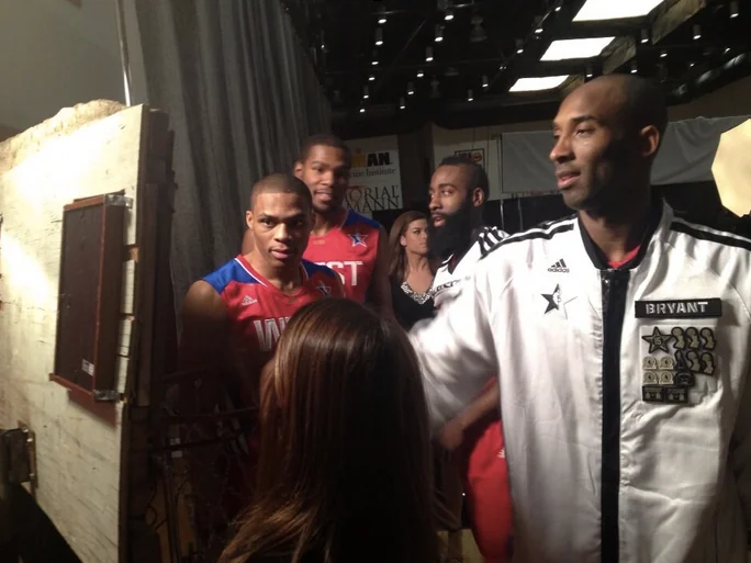 Two men standing backstage at a red-carpet event with a Twitter Mirror.